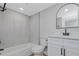 Bathroom featuring a modern vanity, toilet and tub with clean, white and gray marble-patterned walls at 5151 Puritan Cir # 1022, Tampa, FL 33617