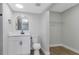 Bathroom with modern vanity, toilet and walk-in closet with white shelving at 5151 Puritan Cir # 1022, Tampa, FL 33617