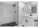 Bathroom featuring walk-in shower with black, stone-pattern floor and modern vanity with black fixtures at 5151 Puritan Cir # 1022, Tampa, FL 33617