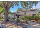 Inviting building exterior with manicured landscaping, pathway, wrought iron fence, and gated entrance for added security at 5151 Puritan Cir # 1022, Tampa, FL 33617