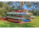 Canoe rack on a green lawn displaying various canoes, perfect for outdoor enthusiasts and water activities at 5151 Puritan Cir # 1022, Tampa, FL 33617