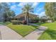 Community clubhouse featuring a metal fence, landscaping, and sidewalk at 5151 Puritan Cir # 1022, Tampa, FL 33617