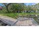 Scenic view of the lake and a wooden dock surrounded by lush greenery offering a serene waterside experience at 5151 Puritan Cir # 1022, Tampa, FL 33617
