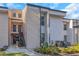 Two-story condo with modern architecture, neutral colors, and a well-maintained front yard and landscaping at 5151 Puritan Cir # 1022, Tampa, FL 33617