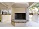Close-up shot of the community fireplace with brick surround in covered seating area at 5151 Puritan Cir # 1022, Tampa, FL 33617