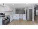 Modern white kitchen with stainless steel appliances and new countertop is move-in ready at 5151 Puritan Cir # 1022, Tampa, FL 33617