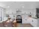 Modern kitchen with white cabinets, stainless steel appliances, and a dining area at 5151 Puritan Cir # 1022, Tampa, FL 33617