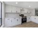 Bright kitchen featuring white cabinetry, stainless steel appliances, and modern countertops at 5151 Puritan Cir # 1022, Tampa, FL 33617