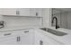 Kitchen featuring white cabinetry, modern countertops, and a stylish black faucet at 5151 Puritan Cir # 1022, Tampa, FL 33617