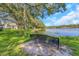 Picturesque lake view featuring a bench, lush greenery, and a serene waterfront, ideal for relaxation and nature enjoyment at 5151 Puritan Cir # 1022, Tampa, FL 33617