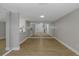 Spacious living room with mirrored wall, open layout, laminate flooring, and modern lighting at 5151 Puritan Cir # 1022, Tampa, FL 33617