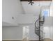 Living room with vaulted ceilings, spiral staircase, ceiling fan, and modern lighting fixtures at 5151 Puritan Cir # 1022, Tampa, FL 33617