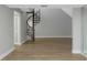 Open living room featuring laminate flooring, a spiral staircase, and minimalist decor at 5151 Puritan Cir # 1022, Tampa, FL 33617