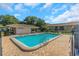 Community pool featuring brick surround, lounge chairs, and adjacent clubhouse at 5151 Puritan Cir # 1022, Tampa, FL 33617