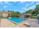 Community pool featuring lounge chairs, clubhouse, and nearby apartment buildings at 5151 Puritan Cir # 1022, Tampa, FL 33617