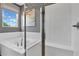 Modern bathroom featuring a soaking tub, glass-enclosed shower, and stylish tile work at 9195 Players Dr, Weeki Wachee, FL 34613