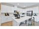Modern kitchen featuring sleek white cabinetry, stainless steel appliances, and a quartz countertop island at 9195 Players Dr, Weeki Wachee, FL 34613
