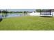 Spacious backyard featuring a vinyl fence and scenic views of the nearby pond at 2746 Walden Woods Dr, Plant City, FL 33566