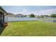 A large, well-maintained backyard is completely enclosed with a white vinyl fence at 2746 Walden Woods Dr, Plant City, FL 33566