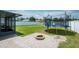Spacious backyard featuring lush green grass, a fire pit, and a fun trampoline at 2746 Walden Woods Dr, Plant City, FL 33566