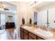 Bathroom featuring double sink vanity, ample counter space, and views into an adjacent bedroom at 2746 Walden Woods Dr, Plant City, FL 33566