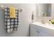 Bright bathroom featuring a white vanity with modern fixtures and decorative daisy-themed towels at 2746 Walden Woods Dr, Plant City, FL 33566