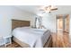 Spacious bedroom with wood floors, neutral walls and a comfortable bed, and doorway to bathroom at 2746 Walden Woods Dr, Plant City, FL 33566
