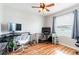 Bedroom featuring a ceiling fan, wood floors, and work from home space at 2746 Walden Woods Dr, Plant City, FL 33566