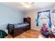 Cozy bedroom featuring wood floors, ceiling fan, and a unique raised bed with built-in storage at 2746 Walden Woods Dr, Plant City, FL 33566