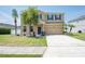 Inviting two-story home with a well-manicured lawn, a two-car garage, and elegant landscaping at 2746 Walden Woods Dr, Plant City, FL 33566