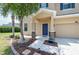 Inviting entryway with decorative stone accents, a covered porch, and lush landscaping at 2746 Walden Woods Dr, Plant City, FL 33566
