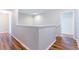 This is a picture of a hallway with hardwood floors, with white trim and neutral walls at 2746 Walden Woods Dr, Plant City, FL 33566