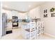 Well-lit kitchen features white cabinets, granite countertops, stainless appliances, and eat-in bar at 2746 Walden Woods Dr, Plant City, FL 33566