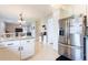 Open kitchen with stainless steel appliances, bar seating and views into the living room at 2746 Walden Woods Dr, Plant City, FL 33566