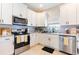 Stainless steel appliances accent the kitchen with granite countertops and white cabinets at 2746 Walden Woods Dr, Plant City, FL 33566