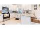 Close up of well-lit kitchen with granite countertops, white cabinets, and stainless steel appliances at 2746 Walden Woods Dr, Plant City, FL 33566