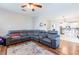 Open floor plan living room with sectional sofa, ceiling fan, and views to kitchen at 2746 Walden Woods Dr, Plant City, FL 33566