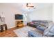 Cozy living room boasts a large sectional sofa, ceiling fan, and television at 2746 Walden Woods Dr, Plant City, FL 33566
