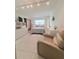 Bright bedroom with white furnishings, tile flooring, and sliding door closet at 870 Virginia St # 108, Dunedin, FL 34698