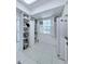Bright kitchen featuring ample shelving, a window with shutters, and modern appliances at 870 Virginia St # 108, Dunedin, FL 34698