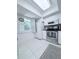Well-lit kitchen with white cabinets, stainless steel appliances, and a view from the window at 870 Virginia St # 108, Dunedin, FL 34698