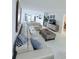 Bright living room with large sectional sofa and decorative accents creating a cozy atmosphere at 870 Virginia St # 108, Dunedin, FL 34698