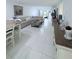 Open-concept living room with tiled floors, comfortable seating, and ample natural light at 870 Virginia St # 108, Dunedin, FL 34698