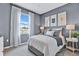 Bedroom featuring a large window, gray walls, and neutral colored furnishings and decor at 9253 Players Dr, Weeki Wachee, FL 34613