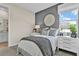 Bedroom with a gray accent wall, white nightstands, and a large window with natural light at 9253 Players Dr, Weeki Wachee, FL 34613