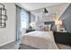 Bedroom with blue curtains, geometric decor, and modern bedside tables and lamps at 9253 Players Dr, Weeki Wachee, FL 34613