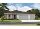 Charming home featuring a three-car garage, stucco exterior, and well-maintained landscaping at 9253 Players Dr, Weeki Wachee, FL 34613