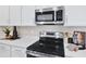 Close-up featuring stainless steel appliances and white cabinetry at 9253 Players Dr, Weeki Wachee, FL 34613