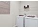 Functional laundry room equipped with a washer, dryer, and convenient shelving at 9253 Players Dr, Weeki Wachee, FL 34613