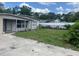 Back yard with a well-maintained lawn, and privacy fence showing the outdoor area at 1009 Kenmore Dr, Brandon, FL 33510